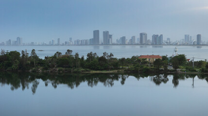 Fototapeta premium Panoramic view of Da Nang city from a scenic viewpoint by the lake on the outskirts of Da Nang city
