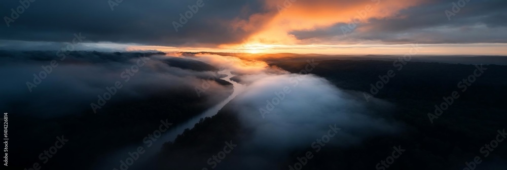 Poster Aerial view of a river cutting through a forest shrouded in mist during sunset creating a mystical scene illuminated by golden light