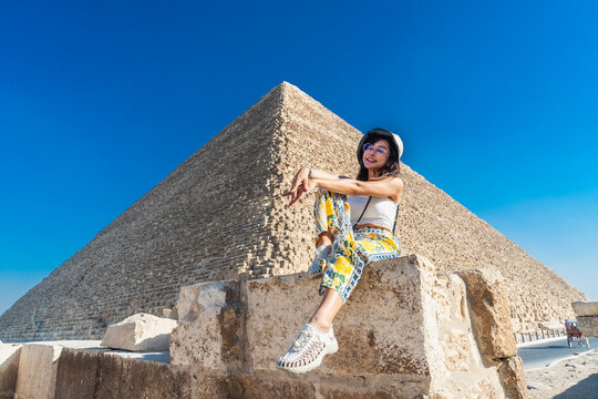Woman posing in front of Cheops pyramid near Cairo in Egypt