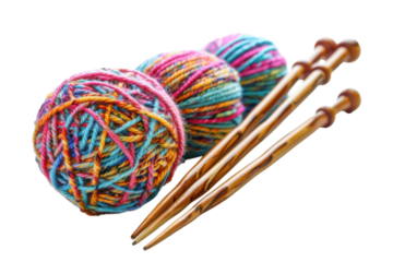 Colorful yarn balls and wooden knitting needles create a cozy crafting atmosphere at home isolated on transparent background