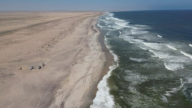 Drone footage of an empty deserted beach along wave sea in Sceleton Coast, Namibia