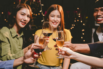 Cheerful multiracial friends dance, drink, and laugh together at a lively nightclub, celebrating friendship, joy, and carefree moments all night.