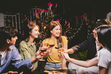 Diverse group of friends joyfully toast with wine and champagne, celebrating success, togetherness,...
