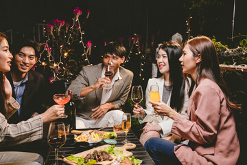 Diverse group of friends joyfully toast with wine and champagne, celebrating success, togetherness, and happiness at an elegant festive gathering.
