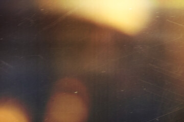 grainy colorful warm orange light leaks on black background with dust texture. abstract damaged scratched retro film analog effect for using over photos as overlay or screen filter