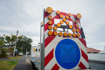 Work truck with cross warning sign. Roadworks in Auckland.