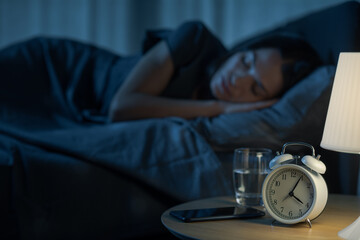 Young relaxed woman sleeping in bed