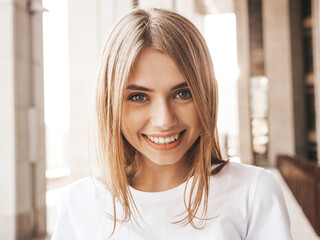 Portrait of beautiful smiling blond model dressed in summer hipster  clothes. Trendy female posing...
