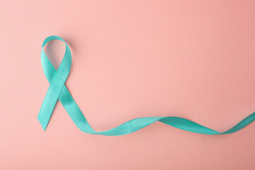 Teal Ribbon Awareness Waving On Pastel Pink Background. World Cancer Day.