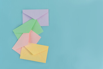 Multicolor envelopes on a blue background, a place for text, the concept of messages and...