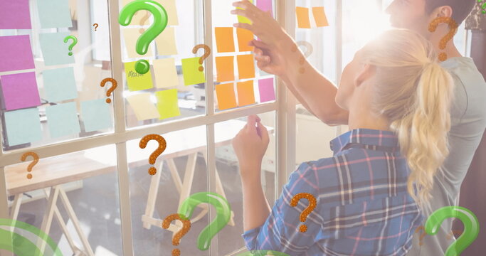 Image of green and red question marks over business people looking at memo notes