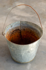 Vintage metal bucket resting on a rustic surface with a touch of nostalgia during soft morning light