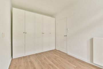 A bright, modern interior showcasing clean lines with light-colored walls and natural wood flooring, enhancing the minimalist aesthetic.