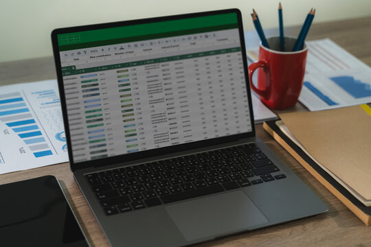A professional analyst uses digital software and spreadsheets to present finance data, charts, and reports in a modern workplace.