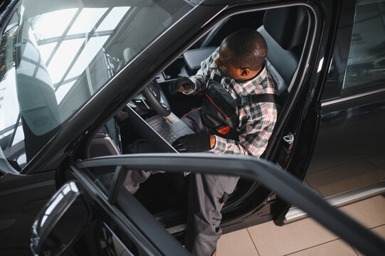 Automobile computer diagnosis. Car mechanic repairer looks for engine failure
