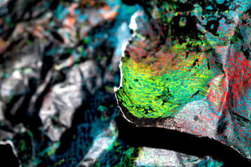 Thick abstract paint surface with heavy texture looking a bit like graffiti hand drawn real dark background