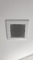 white square ceiling vent with perforated metal grill