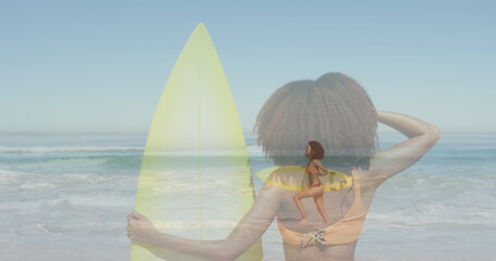 Image of biracial woman with surfboard over biracial woman at beach with surfboard