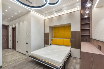 Modern interior design of an open-plan studio apartment. Folding transformer bed, built-in...