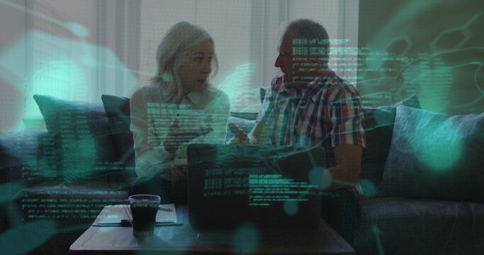 Image of data processing over senior caucasian couple using laptop - Powered by Adobe