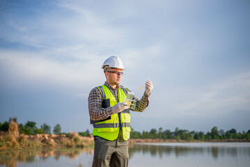A biologist is collecting samples of water from a lake to be tested in a lab on the lake's...