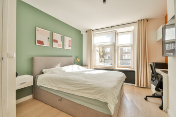 A well-designed bedroom featuring a comfortable bed, stylish decor, and natural light, creating an inviting atmosphere perfect for relaxation.