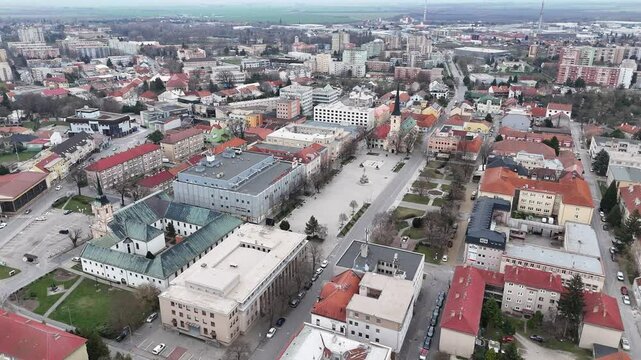 Aerial View of Church of Saint Nicholas and Town Square in Nove Zamky, Slovakia on Cloudy Day