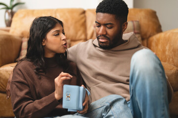 Couple sharing a moment at home while discussing their plans together in a cozy living room setting...