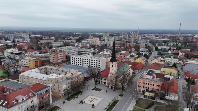 Aerial View of Church of Saint Nicholas and Town Square in Nove Zamky, Slovakia on Cloudy Day