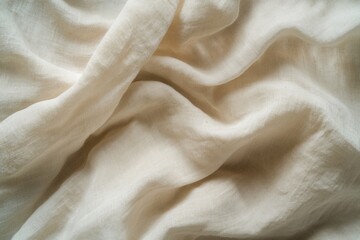 Cream-colored fabric with soft, flowing folds and a subtle texture.
