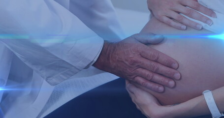 Image of light spots over biracial doctor with caucasian pregnant woman
