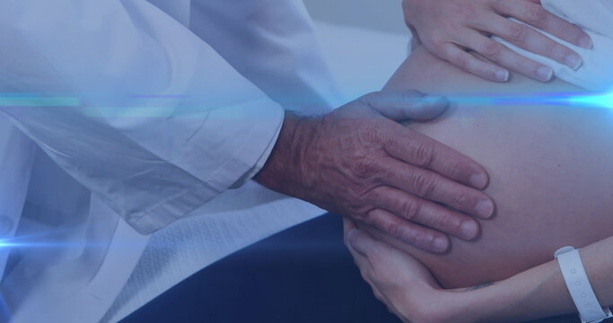 Image of light spots over biracial doctor with caucasian pregnant woman