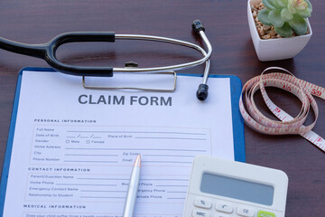 Doctor’s Workstation: Medical Form in Clipboard on Wooden Tabletop