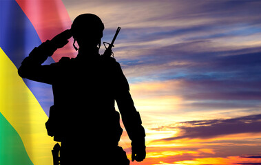 Silhouette of soldier against the sunset with Mauritius flag. National Holidays concept