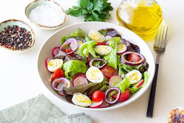 Salad with eggs, tomatoes, onions and radishes. Healthy eating. Vegetarian food.