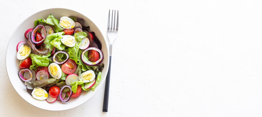 Salad with eggs, tomatoes, onions and radishes. Healthy eating. Vegetarian food.