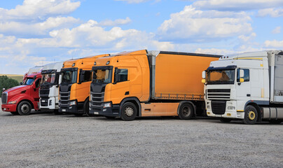Big Trucks in a Parking Lot Outside the City © Yuri Bizgaimer