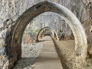 Endless Arches Over Cobblestone Path