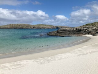 White beach and blue water with rocky background on Sandray Island, outer Hebrides © Jaromir