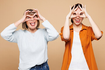 Elder funny parent mom 50s years old with young adult daughter two women together wear casual...