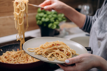 Step by step the process of cooking Italian pasta carbonara in spaghetti, add sauce with fried...