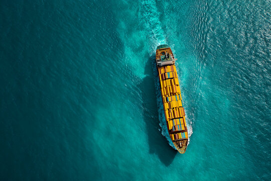 Aerial view of container ship sailing on teal ocean, showcasing global trade and maritime transport, representing international commerce and logistics