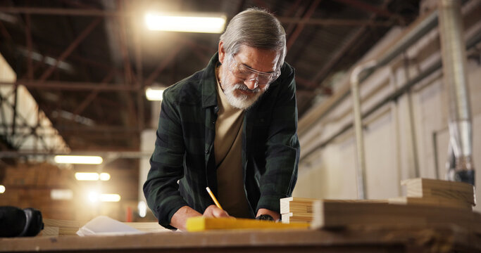 Workshop, carpenter and man with pencil for drawing, manufacturing and architecture project. Construction, mature person and design with blueprint for carpentry, furniture renovation and creativity