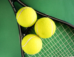 Top view of tennis racket and balls on green background.Sport concept.Promotional background for...