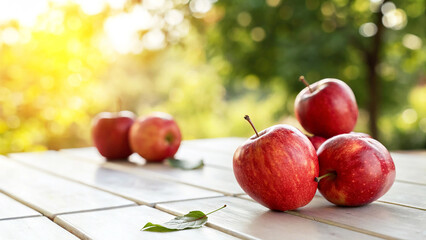 Fresh Red Apples with water drops on white surface in Natural background with warm sunlight