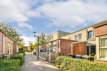 A picturesque view of a residential street showcasing modern architecture, vibrant trees, and...