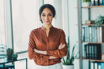 Confident businesswoman standing in a modern office, embodying professionalism and elegance