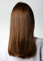 Fototapeta premium Woman with healthy brown hair on white background, back view, isolation