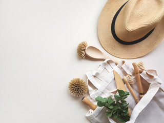 Flat Lay of Eco-Friendly Grooming and Household Accessories on Wooden Surface. Assorted sustainable grooming and household tools made from natural materials, neatly arranged on a wooden surface.