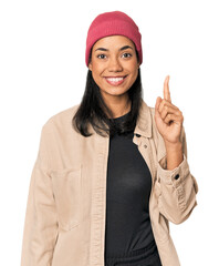 Young Filipino woman in studio showing number one with finger.